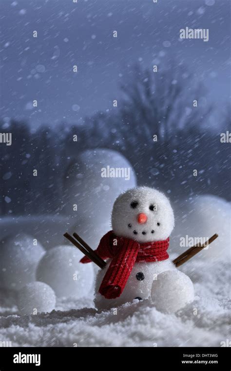 Snowman with winter night snow background Stock Photo - Alamy