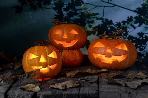 Premium Photo Three Halloween Pumpkins Head Jack O Lantern On Wooden