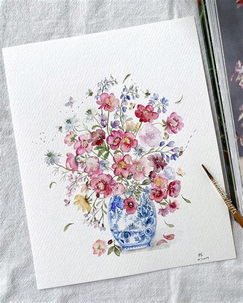 A Watercolor Painting Of Flowers In A Blue And White Vase On A Linen