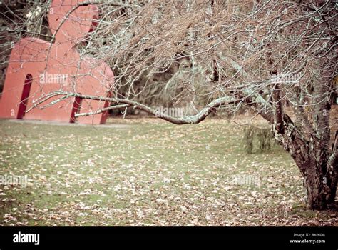 Red Human Figure Behind The Tree Stock Photo Alamy