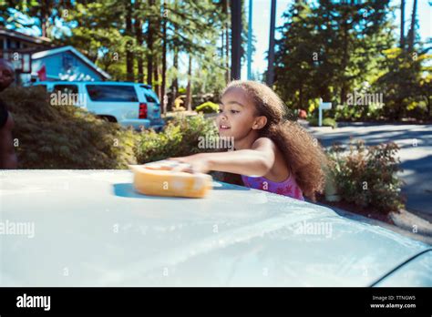 Girl Washing Car In Driveway Stock Photo Alamy