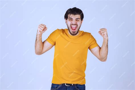 Free Photo Man In Yellow Shirt Showing His Fist And Power