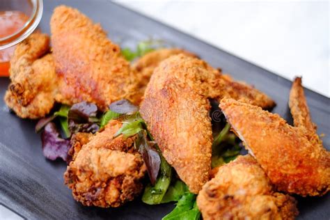 Fried Chicken Wings On Black Plate In Restaurant Stock Photo Image Of