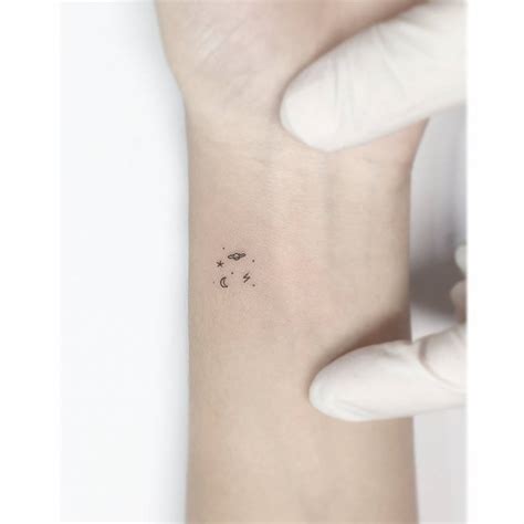 Minimalistic Universe Tattoo Placed On The Wrist