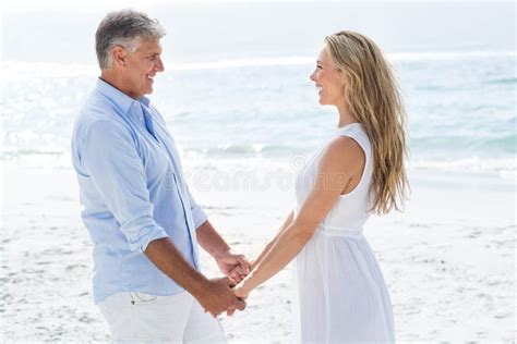 Happy Couple Holding Hands And Smiling At Each Other Stock Image