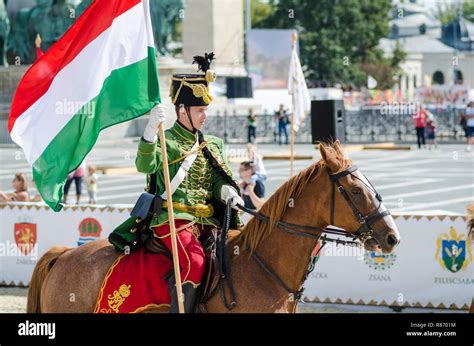 Man In Traditional Military Uniform Riding A Horse And Carrying The