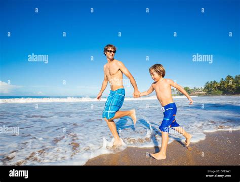 Happy Father And Son Walking Together On The Beach Carefree Happy Fun