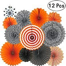 An Assortment Of Orange And Black Paper Fan Decorations On A White