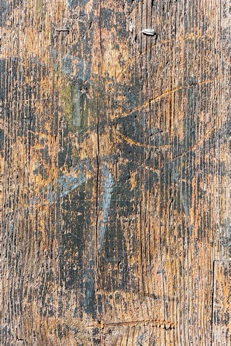 An Old Wooden Surface With Peeling Paint On It