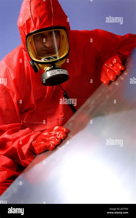 Asbestos Removal With Red Protective Clothing And Ventilator Face Mask