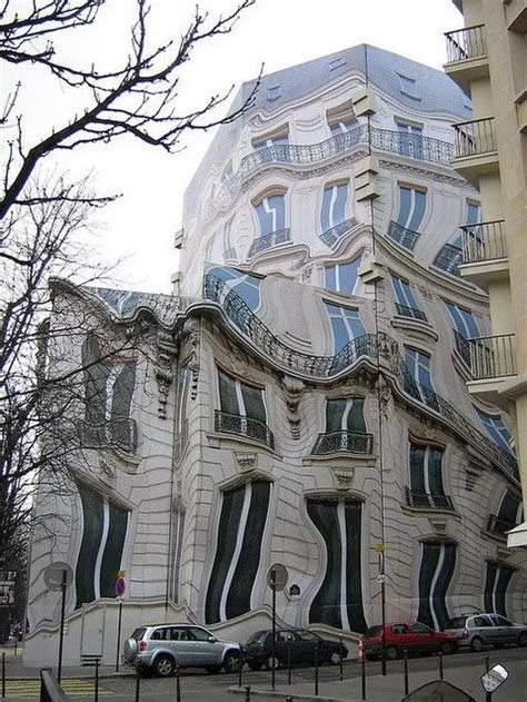the building has many windows and balconies on it's sides, along with ...