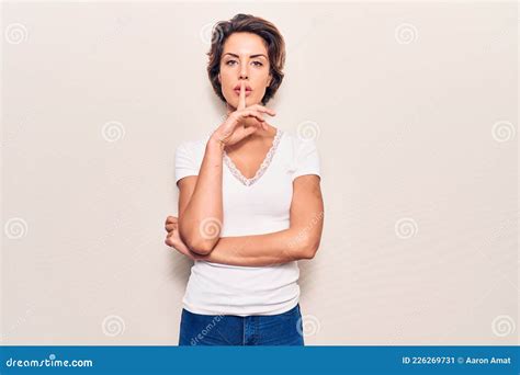 Young Beautiful Woman Wearing Casual Clothes Asking To Be Quiet With Finger On Lips Stock Image