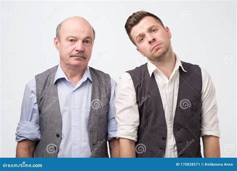Two Mature Men Father And Son Being Sad Negative Facial Emotion Stock