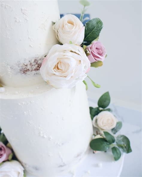 Two Tier White Semi Naked Ganache Wedding Cake With Artificial Flowers