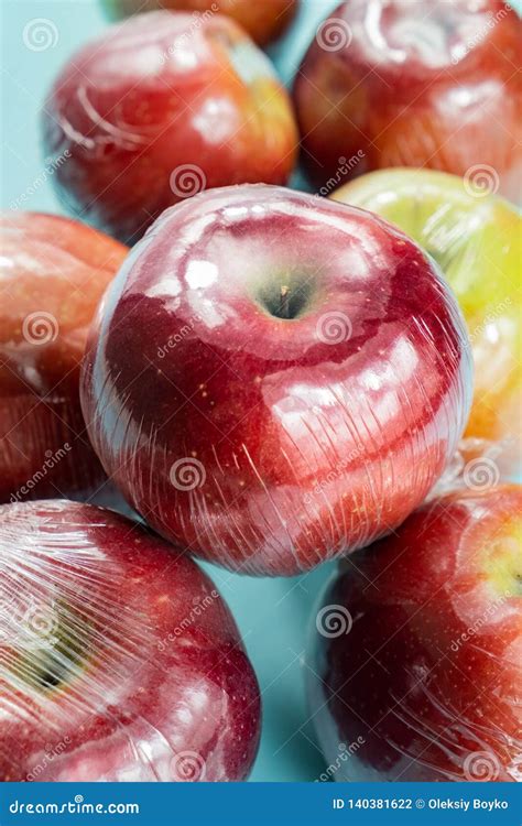 Excessive Plastic Use Concept Fresh Apples In Kitchen Wrap Stock Photo