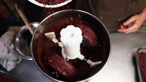 Artisan Chocolatier Grinding Cocoa Beans In Stone Melanger Stock