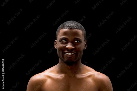 Portrait Of Naked Black Man Looking Away While Posing Over Black Background In Studio Handsome