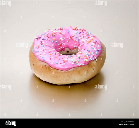 Pink Iced Ring Bun Or Doughnut Stock Photo Alamy