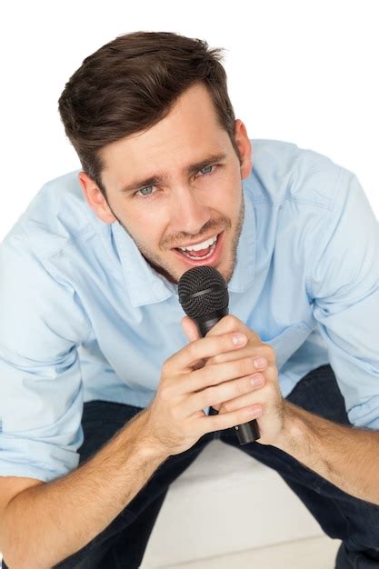 Premium Photo Portrait Of A Young Man Singing Into Microphone