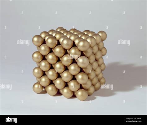 Gold crystal structure. Model showing the face-centred cubic structure of atoms in a gold ...