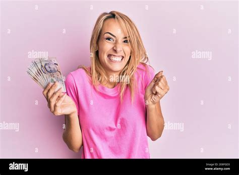 Beautiful Blonde Woman Holding Singapore Dollars Banknotes Screaming