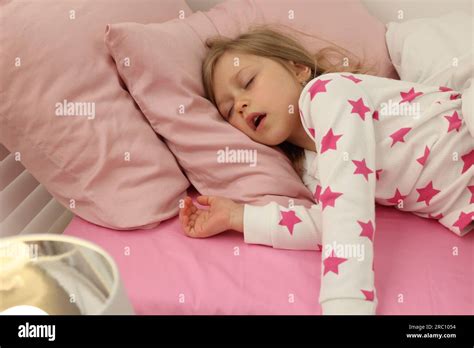 Little Girl Snoring While Sleeping In Bed Stock Photo Alamy