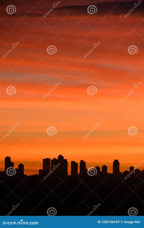 Silhouette Of Residential Buildings On Sunset Sky Background Stock