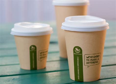 Three Coffee Cups Sitting On Top Of A Wooden Table