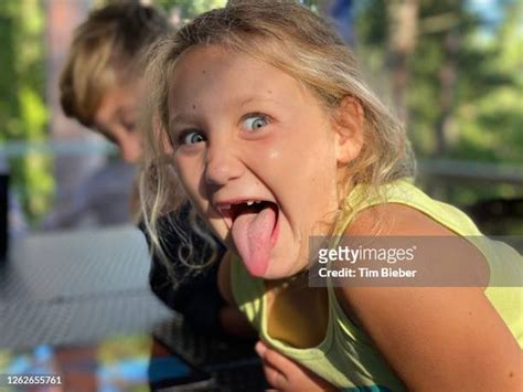 Young Girl Making Funny Face Sticking Out Her Tongue High Res Stock