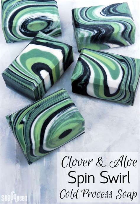 Soap Bars With Green And Black Swirl Designs On Them Sitting On A