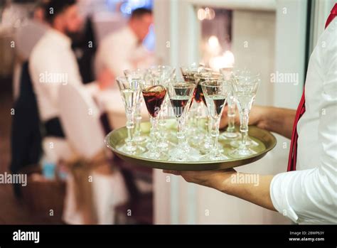 Waiter Carrying Tray With Several Various Alcoholic Drinks Man Serving