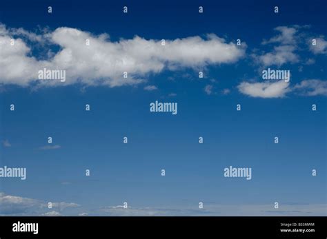 Fluffy Clouds In A Blue Sky Stock Photo Alamy