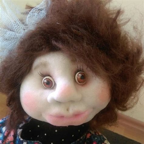 A Close Up Of A Doll With Hair On Top Of It S Head And Eyes