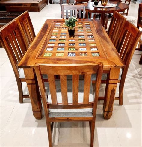 A Wooden Table With Chairs Around It In A Store