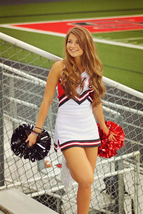 A Cheerleader Is Standing On The Bleachers