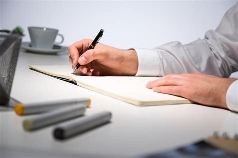 Premium Photo | Businessman writing in journal