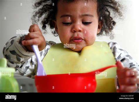 Toddler Feeding Herself Stock Photo Alamy