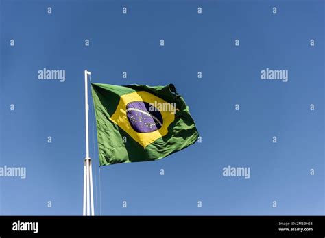 Flag Of Brazil Fluttering In The Wind In The Center Of The Flag With