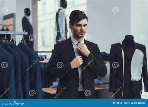 Successful Young Businessman Measures Jacket In Business Mens Clothing