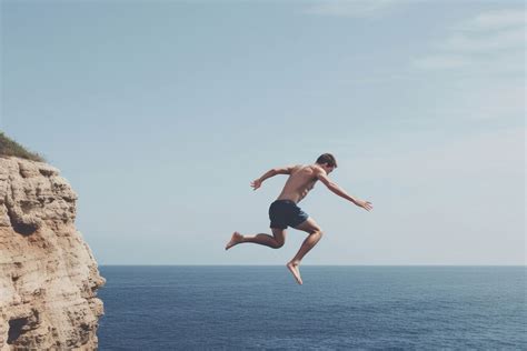 Sea jumping diving cliff. AI | Premium Photo - rawpixel