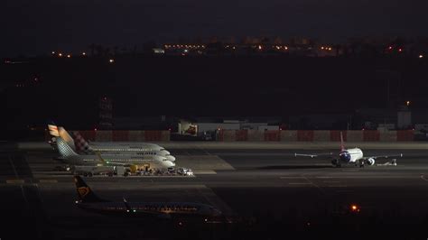 Side view of planes on the runway at the airport at night 28765810 ...