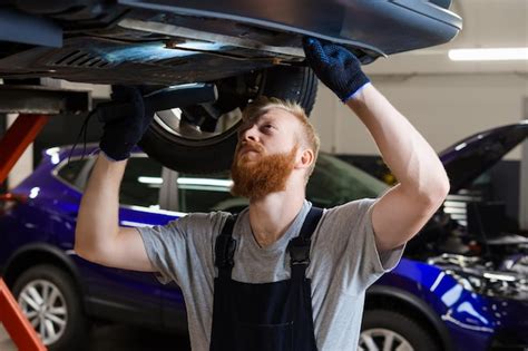 Premium Photo Inspection Of The Car Suspension A Male Engineer In