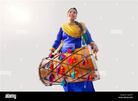Portrait Of Sikh Woman Playing Drum During Baisakhi Celebration Stock