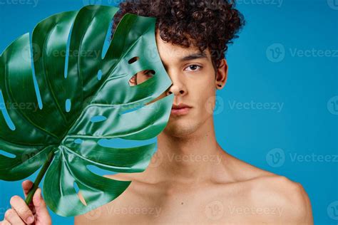 Handsome Man With Curly Hair Naked Shoulders Green Leaf Clear Skin