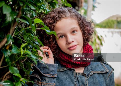 Portrait Of Curly Short Hair Girl Wearing Red Knitting Collar Stock