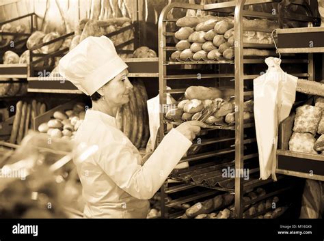 Bakery Mature Female Employee With Tasty Bread Products On Counter