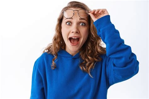 Premium Photo Excited Young Woman Takes Off Glasses And Stare At