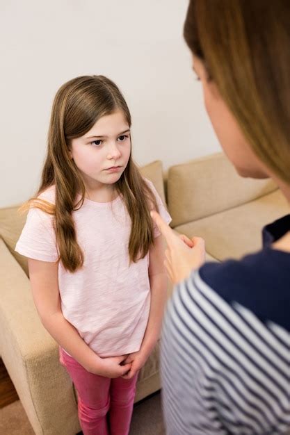 Mother Scolding Her Daughter In Living Room Photo Free Download