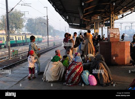 Indian people standing sitting on the platform of Delhi Railway Stock ...