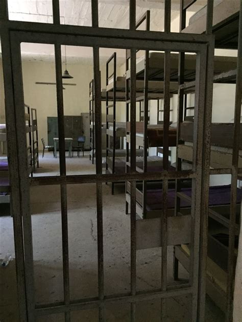 The Room Is Filled With Bunk Beds And Chairs